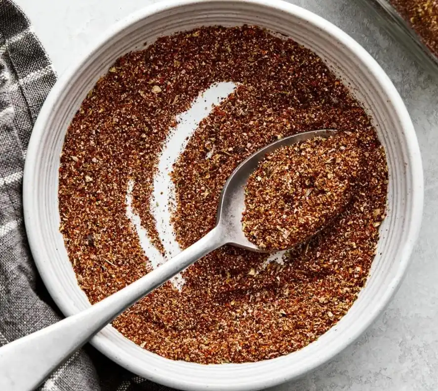 Homemade taco seasoning recipe stored in a sealed glass spice jar with a handwritten label showing the date