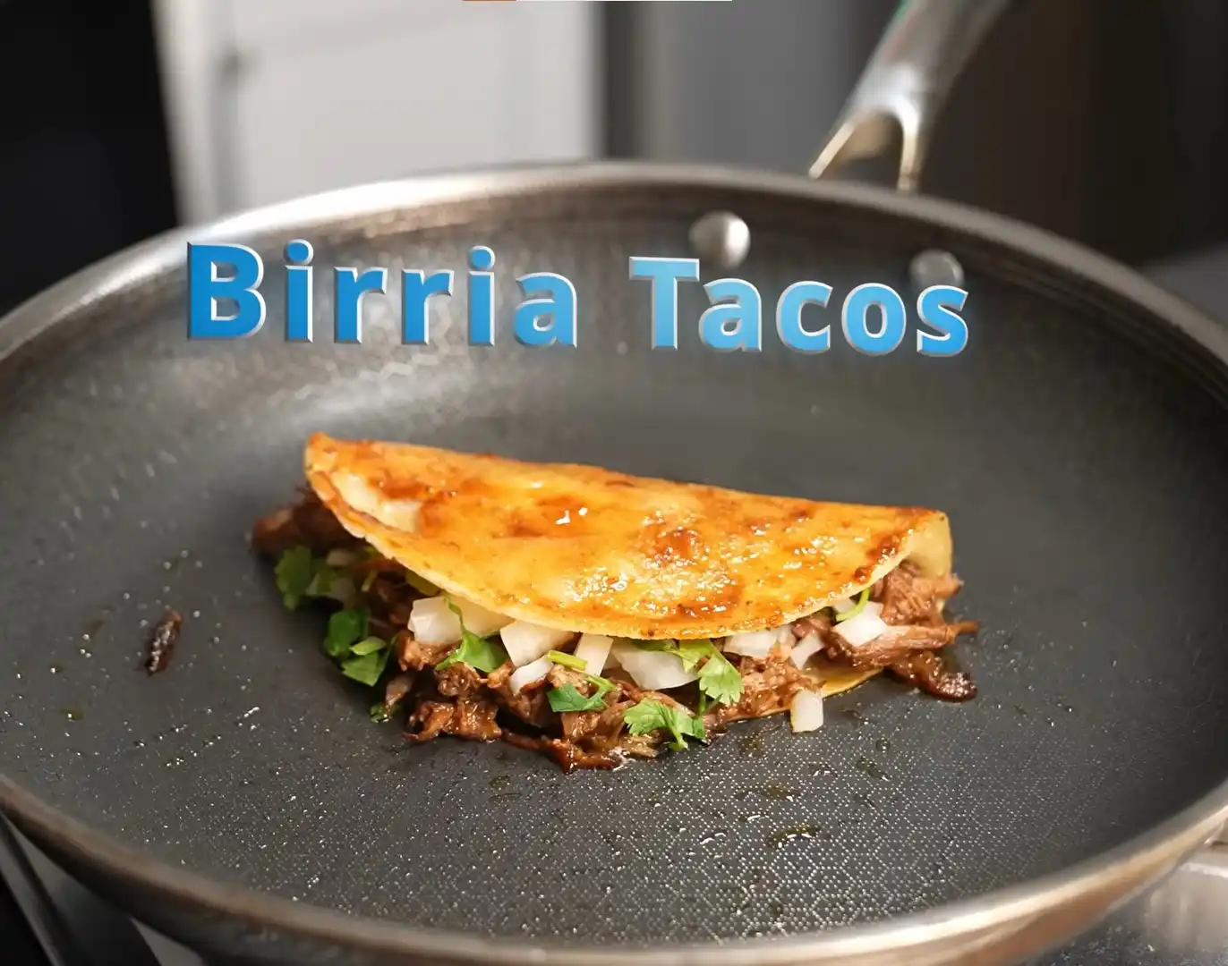 Homemade birria tacos with crispy tortillas, shredded beef, cheese, and consomé