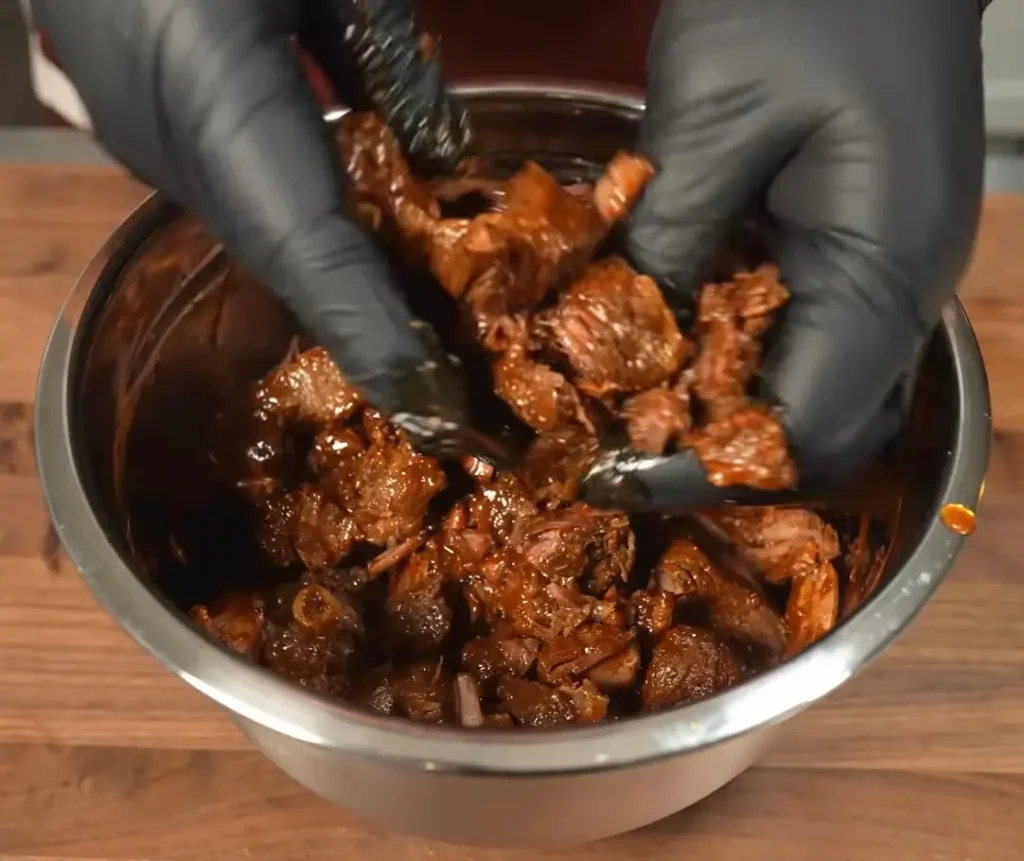 Tender shredded beef prepared for birria tacos
