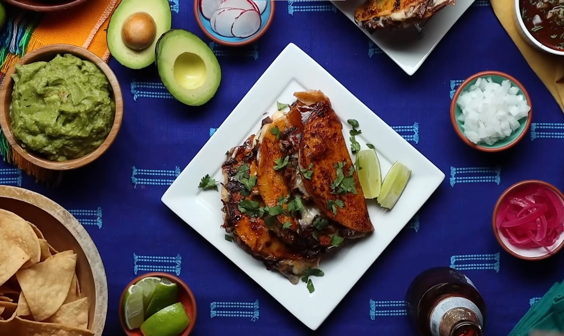 Authentic birria tacos with consomé dipping sauce on a wooden board