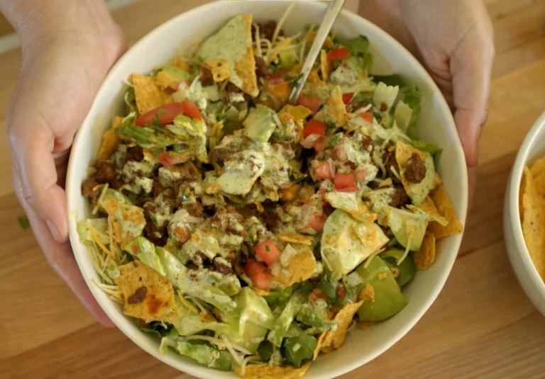 creamy chipotle ranch dressing for taco salad in a small jar with lime wedges