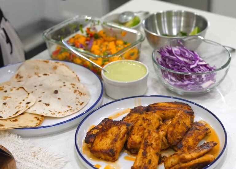 Fried fish taco with cabbage slaw, pickled onions and lime crema